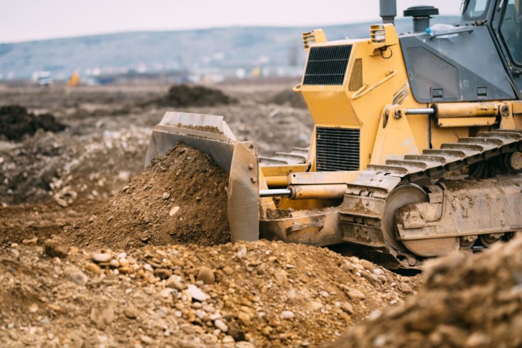 highway construction site close up with industrial machinery excavator and bulldozer working